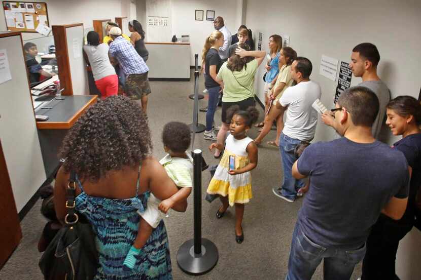 
Passport applicants waited in line last week at the George Allen Sr. Courts Building in...