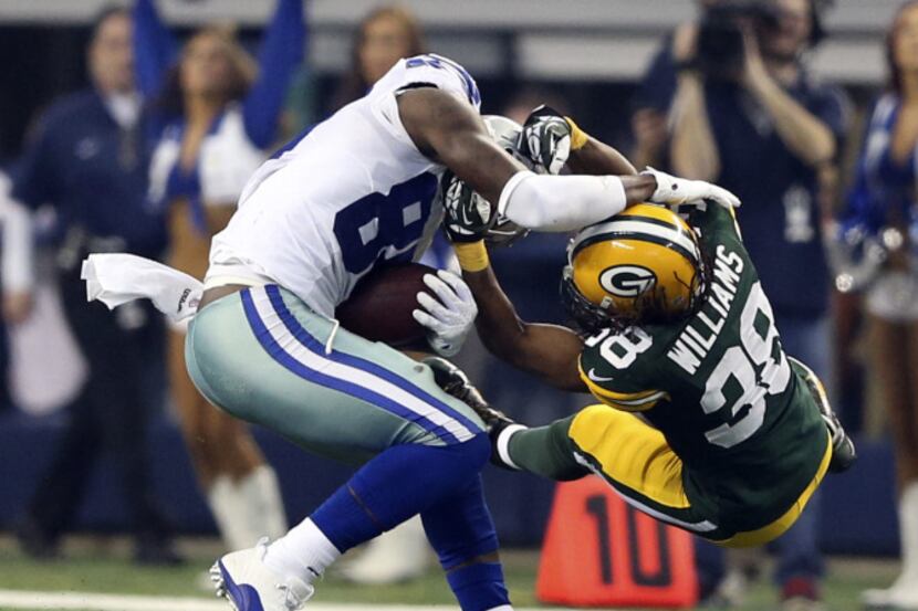 Dallas Cowboys wide receiver Dez Bryant (88) sheds off Green Bay Packers cornerback Tramon...