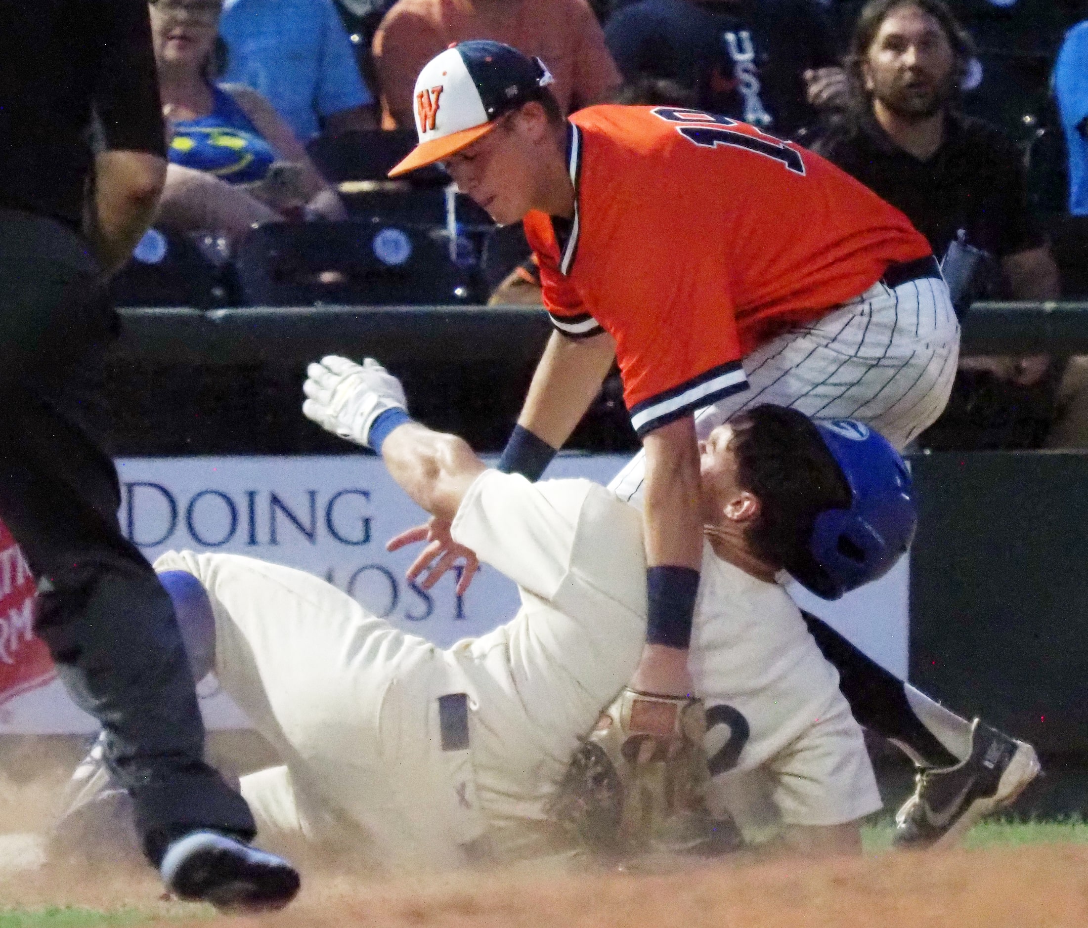 Frisco Wakeland third baseman Jack Bryan (right) tags out  Georgetown baserunner Zachary...