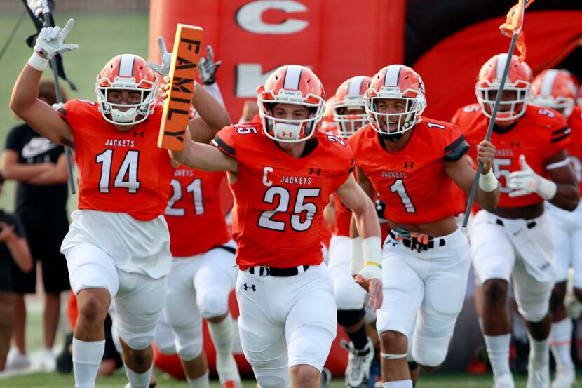 The Rockwall Yellowjackets take the field during the first half of a high school football...
