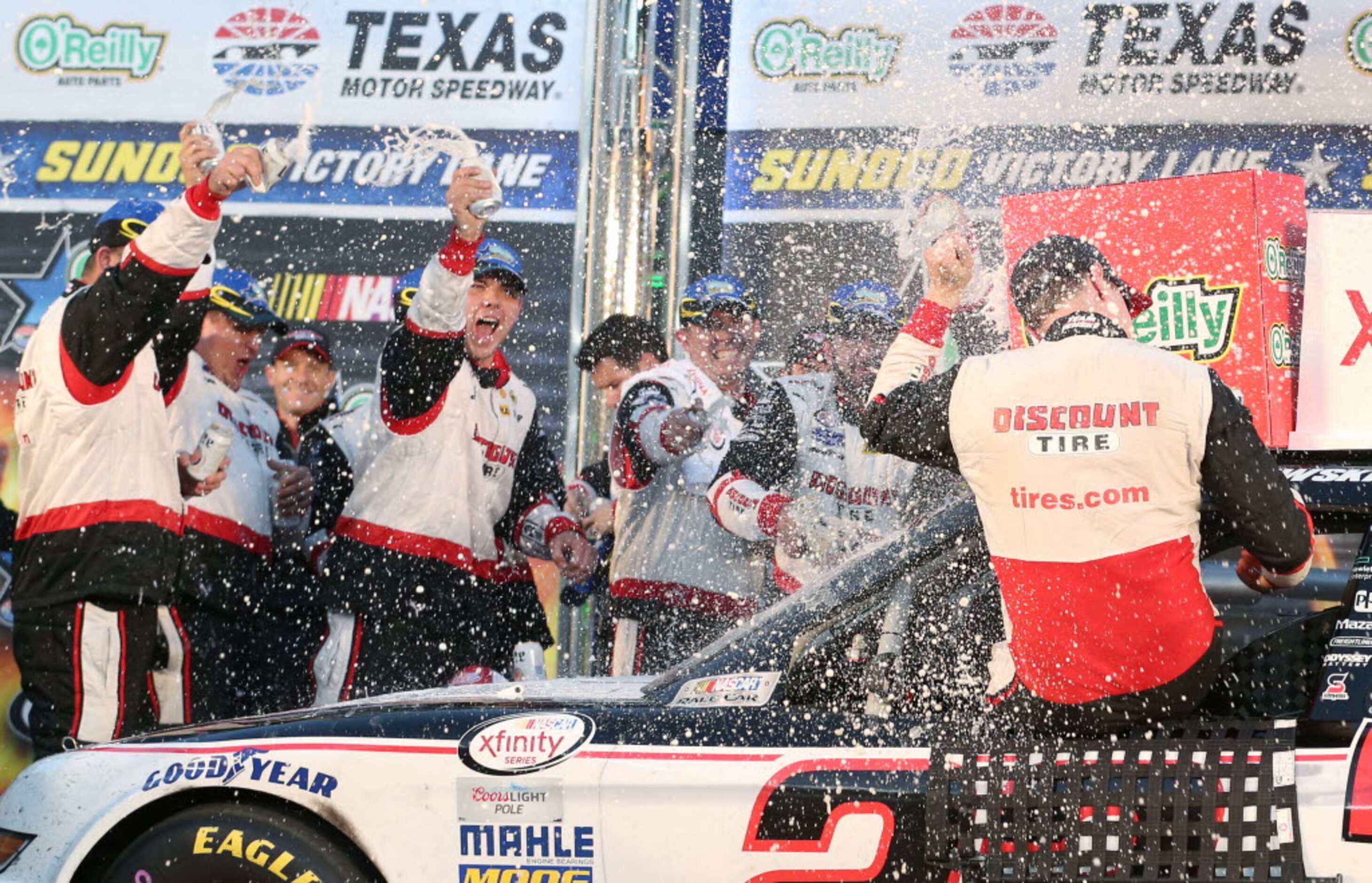 Brad Keselowski (22) is doused by his pit crew as they celebrate winning the NASCAR XFINITY...