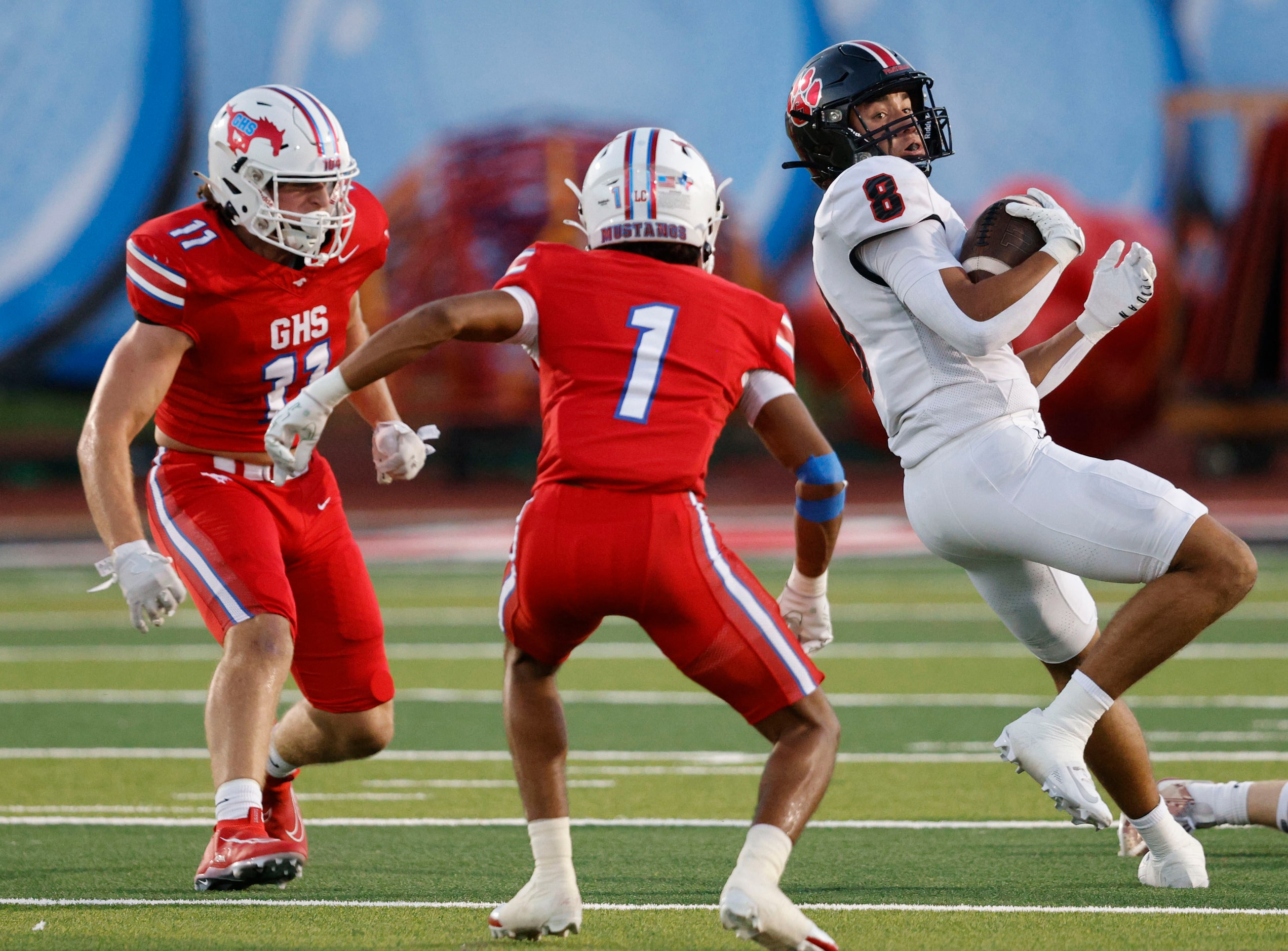 Colleyville Heritage's Braden Blueitt (8) keeps a ball away from Grapevine's Tatum Evans...