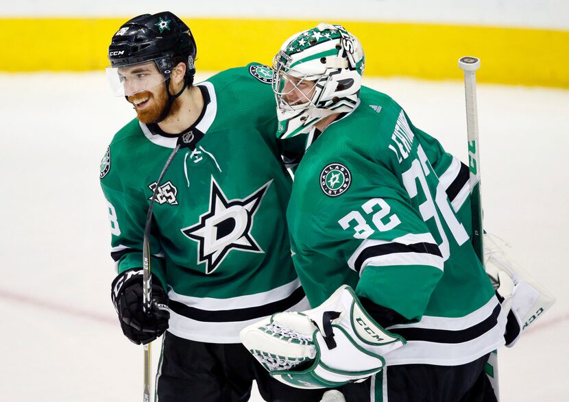 Dallas Stars defenseman Stephen Johns (28) congratulates goaltender Kari Lehtonen (32) after...