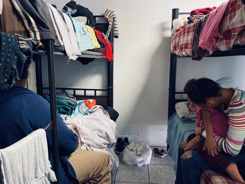 Two Honduran mothers cuddle their toddlers this week inside a migrant shelter in Mexico....