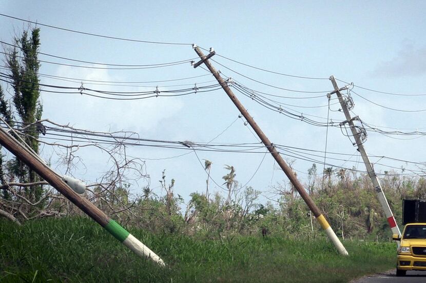 Power poles lean precariously along Highway 118 near San Isidro, Puerto Rico. About 86...