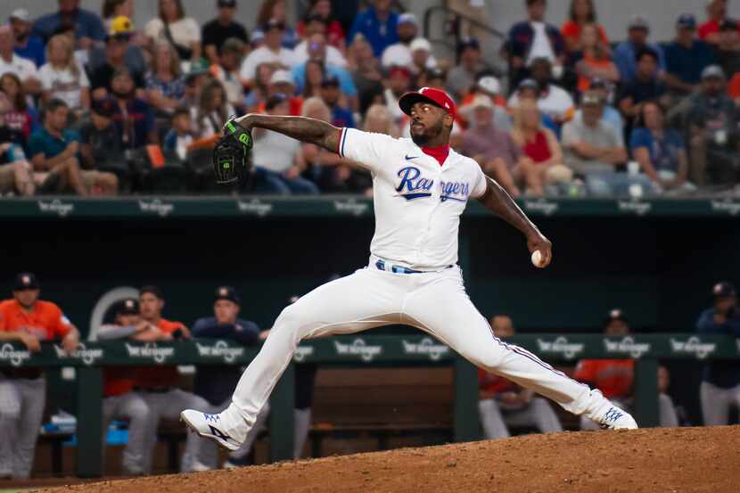 Texas Rangers relief pitcher Aroldis Chapman delivers a pitch in the top of the eighth...