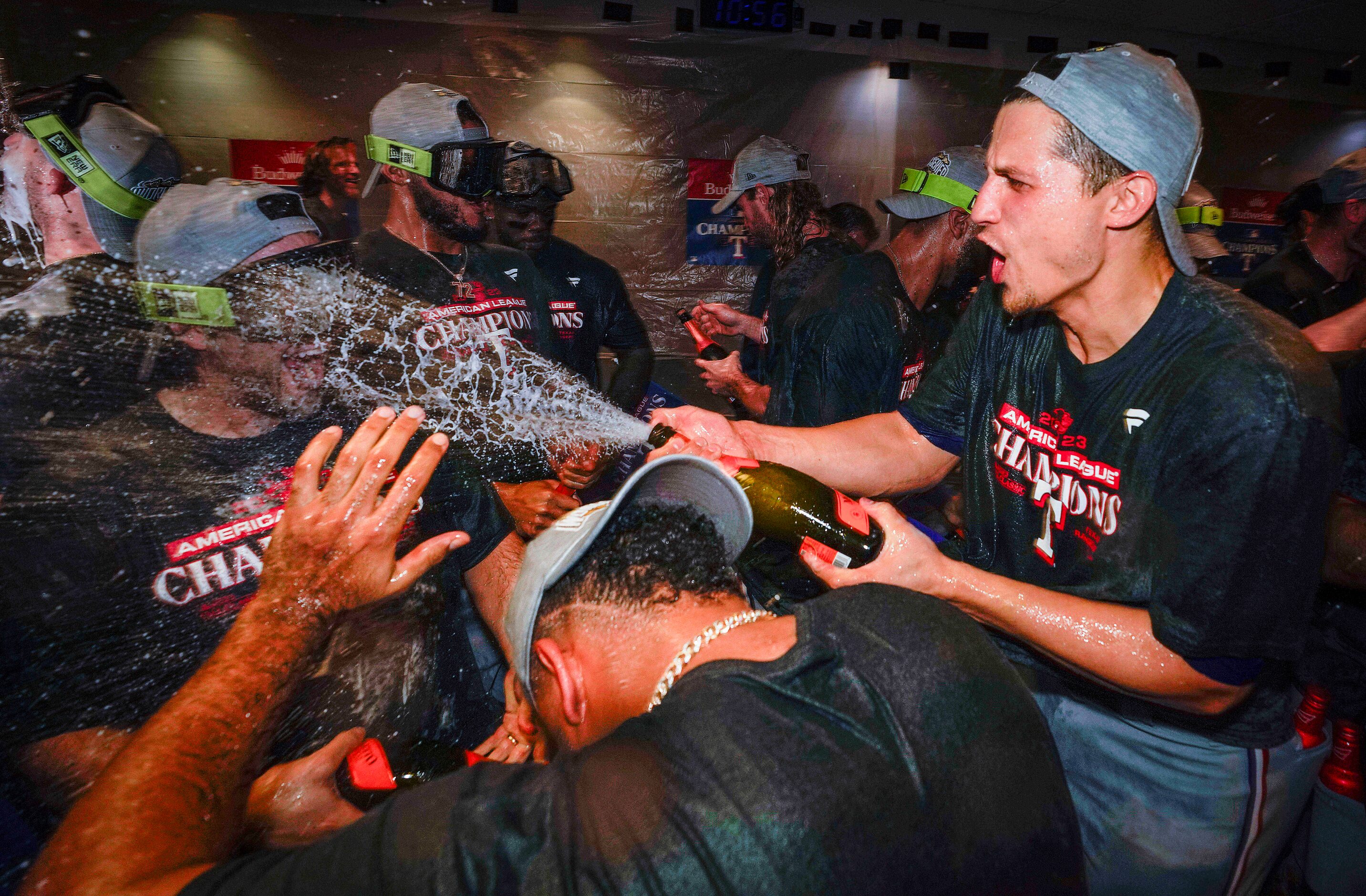 Texas Rangers shortstop Corey Seager (right) celebrates in the clubhouse after the Rangers...