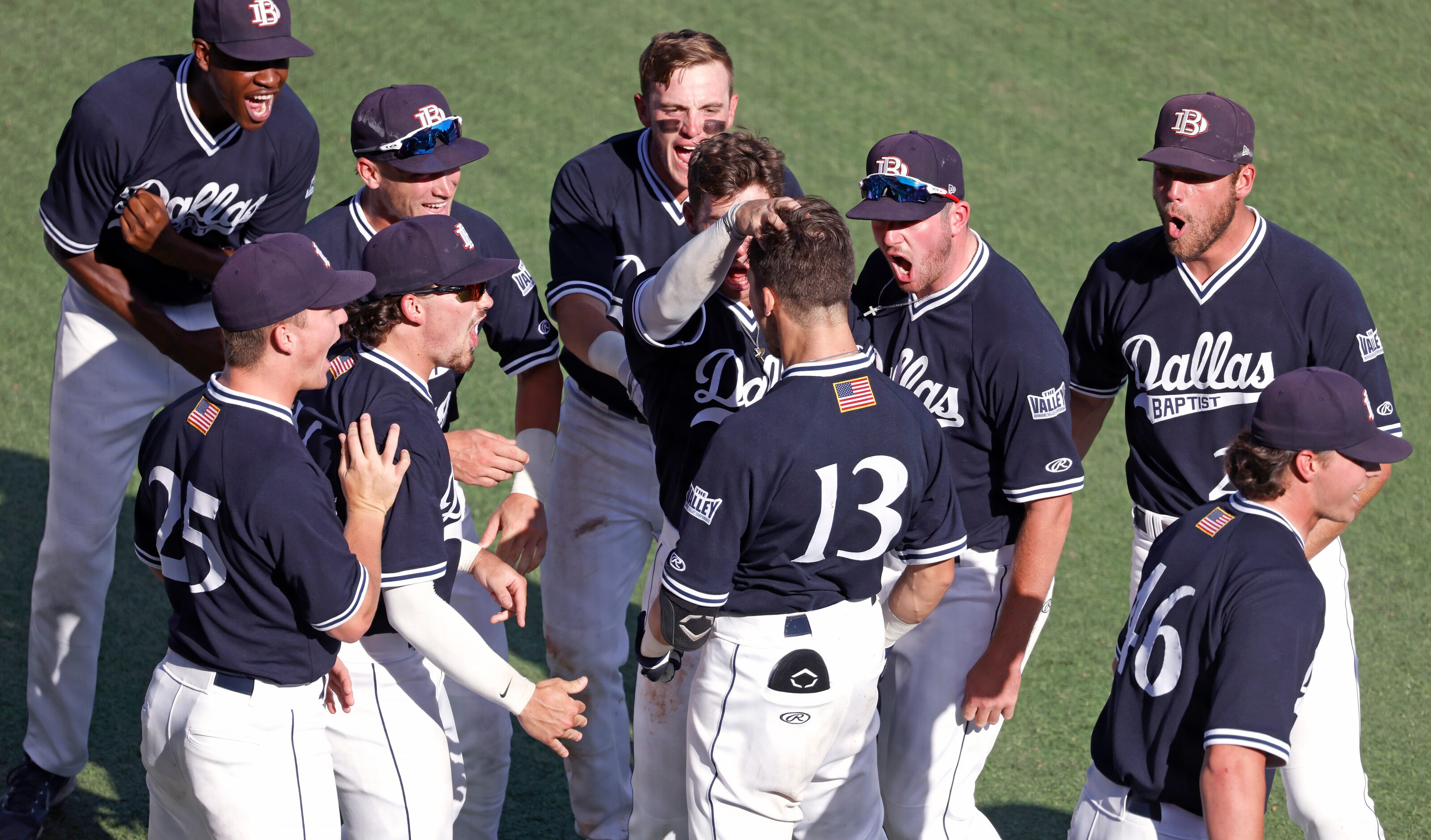 Dallas Baptist infielder Andrew Benefield (13) celebrates with teammates after hitting a...