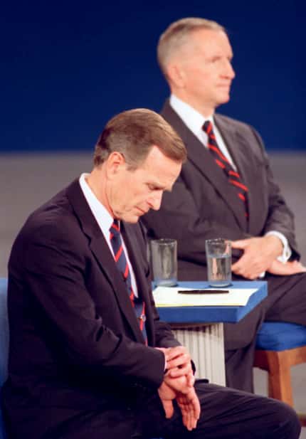 In a classic debate moment, President George H.W. Bush looks at his watch during a...
