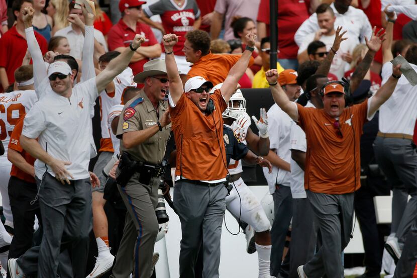 Texas Longhorns Head Coach Tom Herman (center) celebrates with other staff members after the...