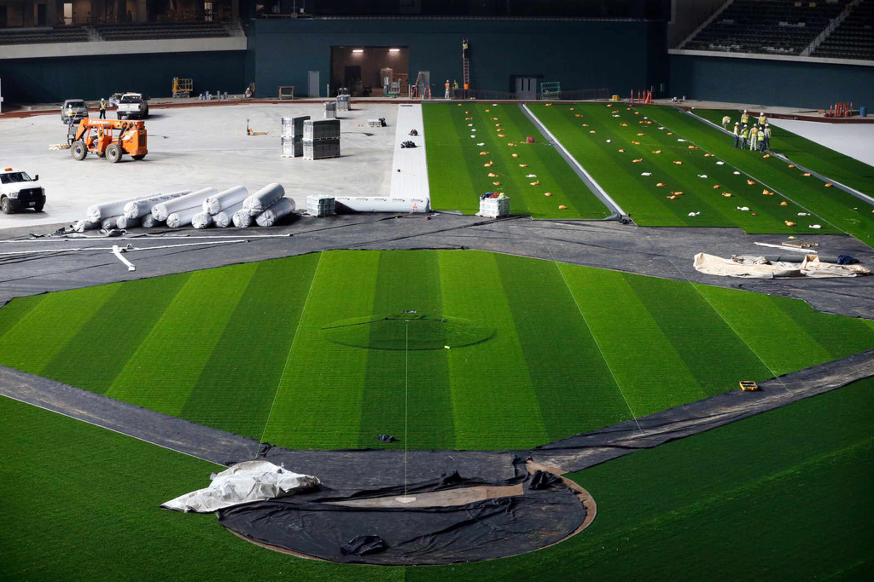 The synthetic grass by Shaw Sports Turf is being installed at Globe Life Field under...