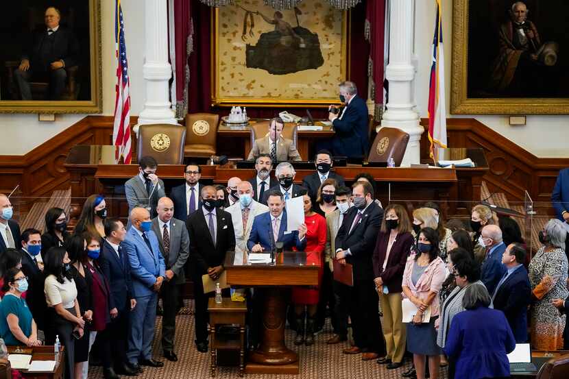 Democrats gather around Rep. Rafael Anchía, D-Dallas, as he speaks in opposition to SB-7 on...