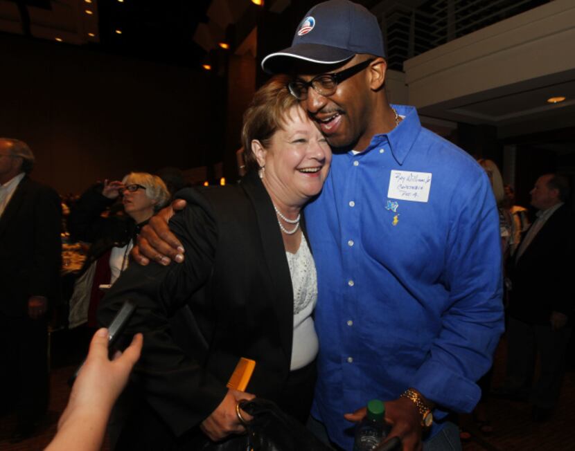 County Commissioner candidate Theresa Daniel  gets a hug from Roy Williams Jr., constable...