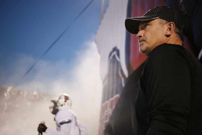 Cedar Hill head coach Joey McGuire watches his players enter the field before a high school...