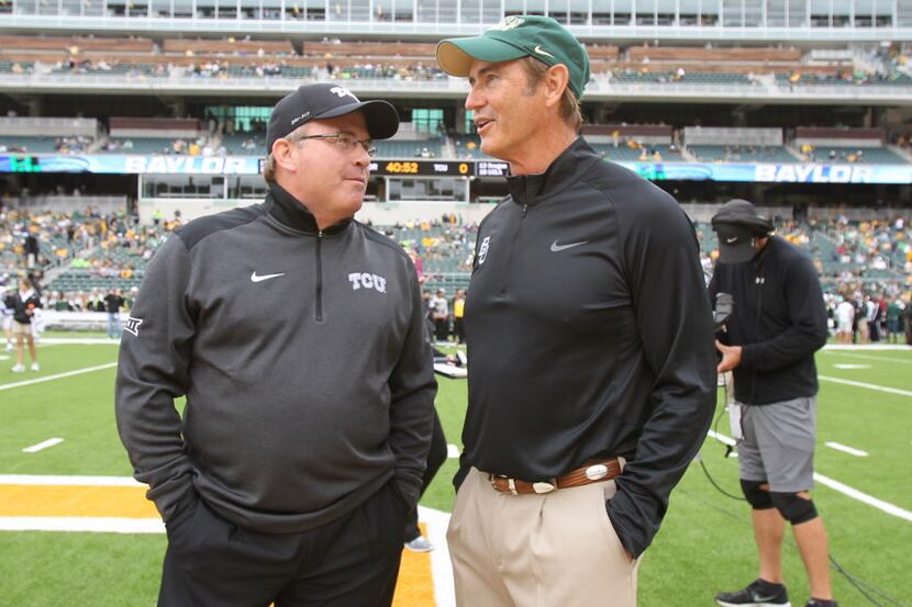 Baylor coach Art Briles, right and TCU Gary Patterson talks before their NCAA college...