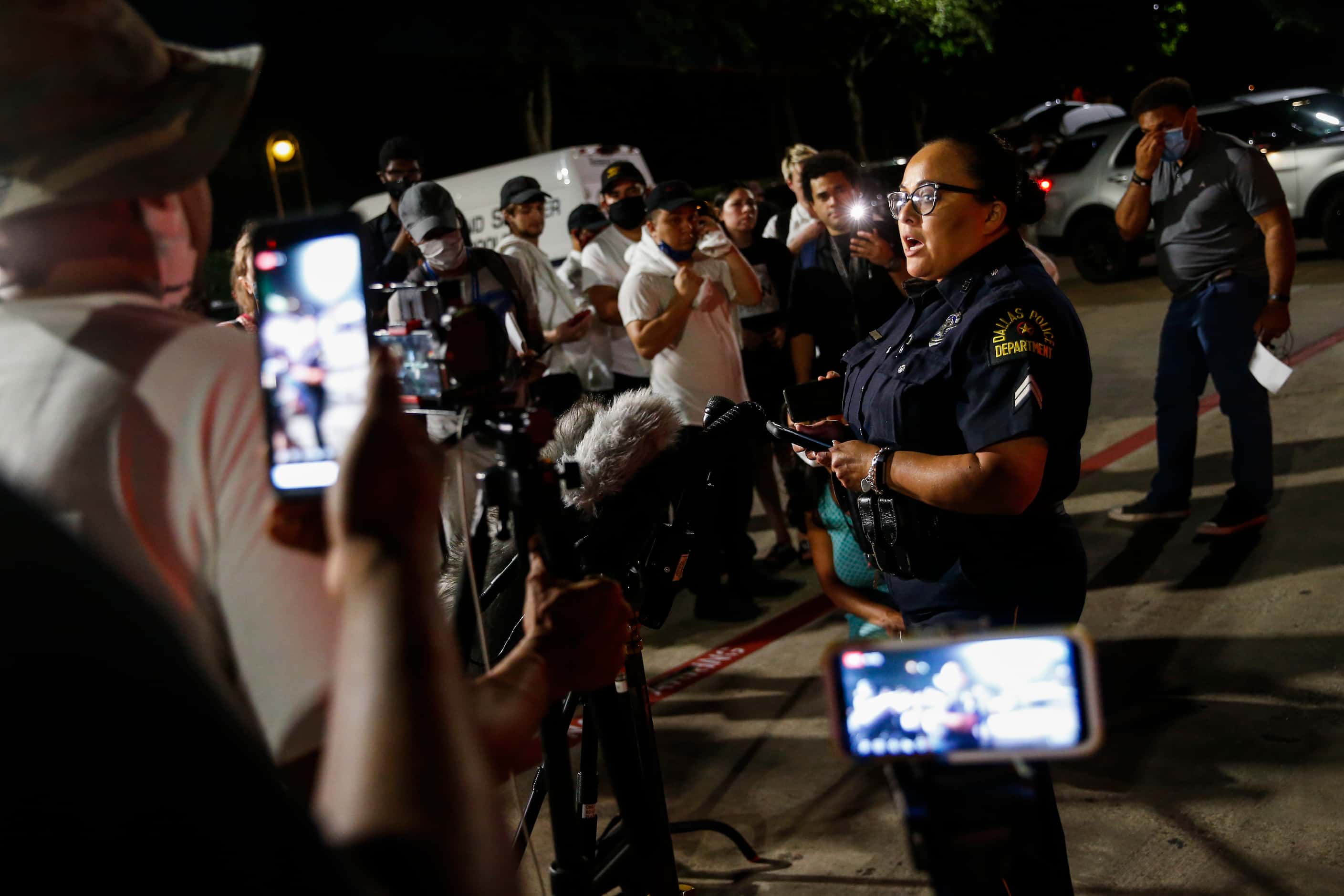 Dallas Police Senior Corporal Melinda Gutierrez addresses members of the media outside of...
