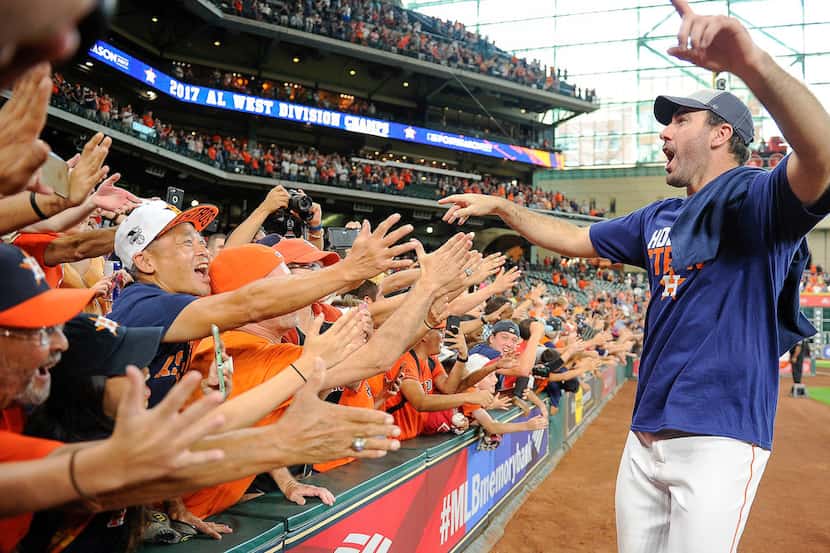 Houston Astros' Justin Verlander celebrates with fans after the team's win over the Seattle...