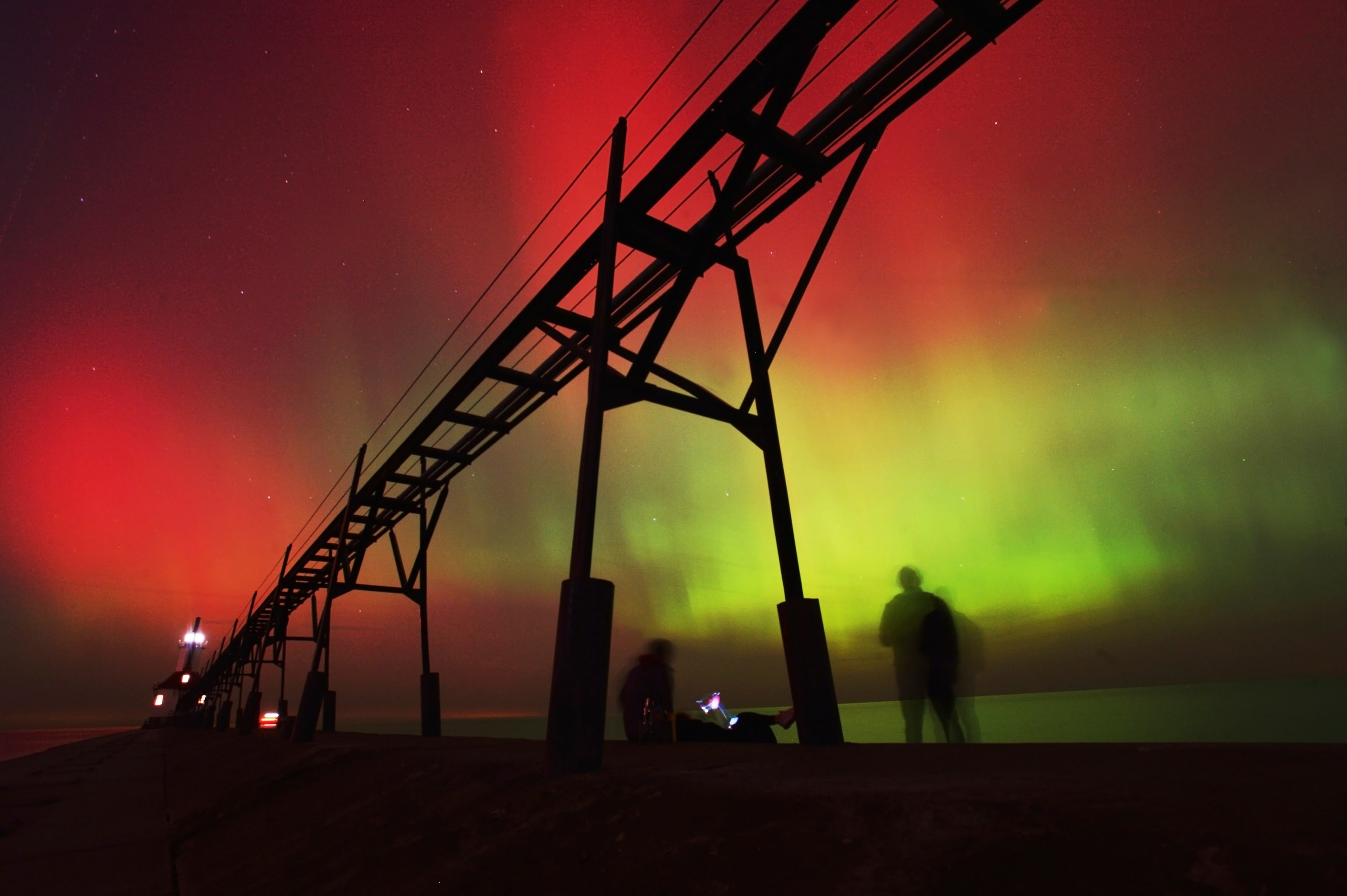 An aurora borealis, also known as the northern lights, lights up the night sky off Lake...