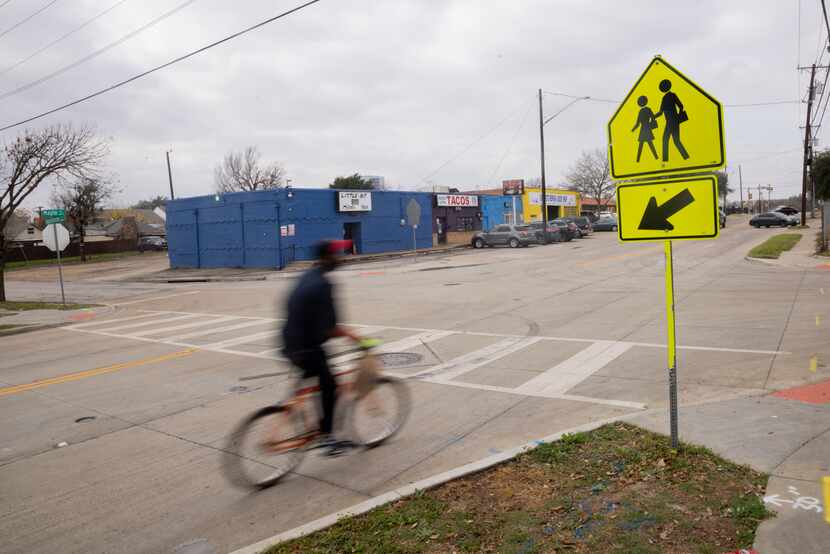 A cyclist goes through the intersection of Hawthorne Avenue and Maple Avenue in Dallas on...