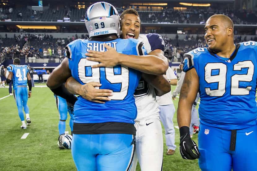 Dallas Cowboys defensive end Greg Hardy hugs Carolina Panthers defensive tackle Kawann Short...