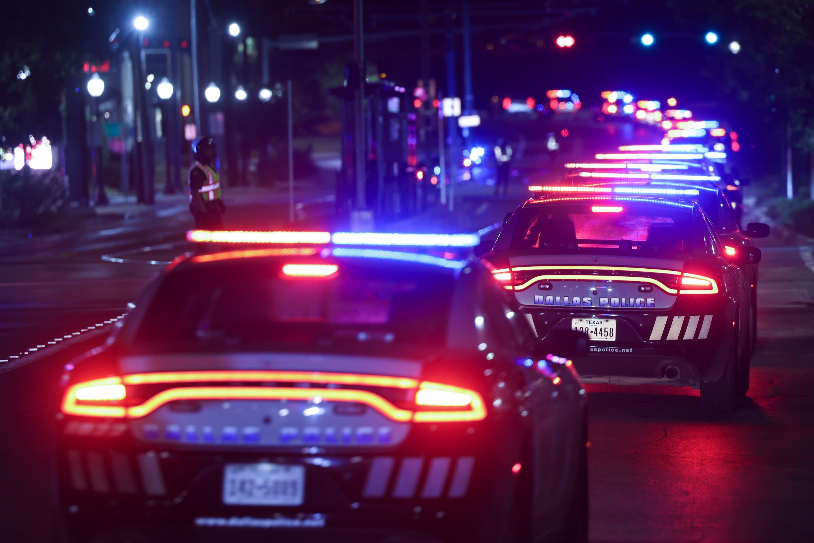 Dallas Police Department officers carry a procession along Colorado Blvd. towards Dallas...