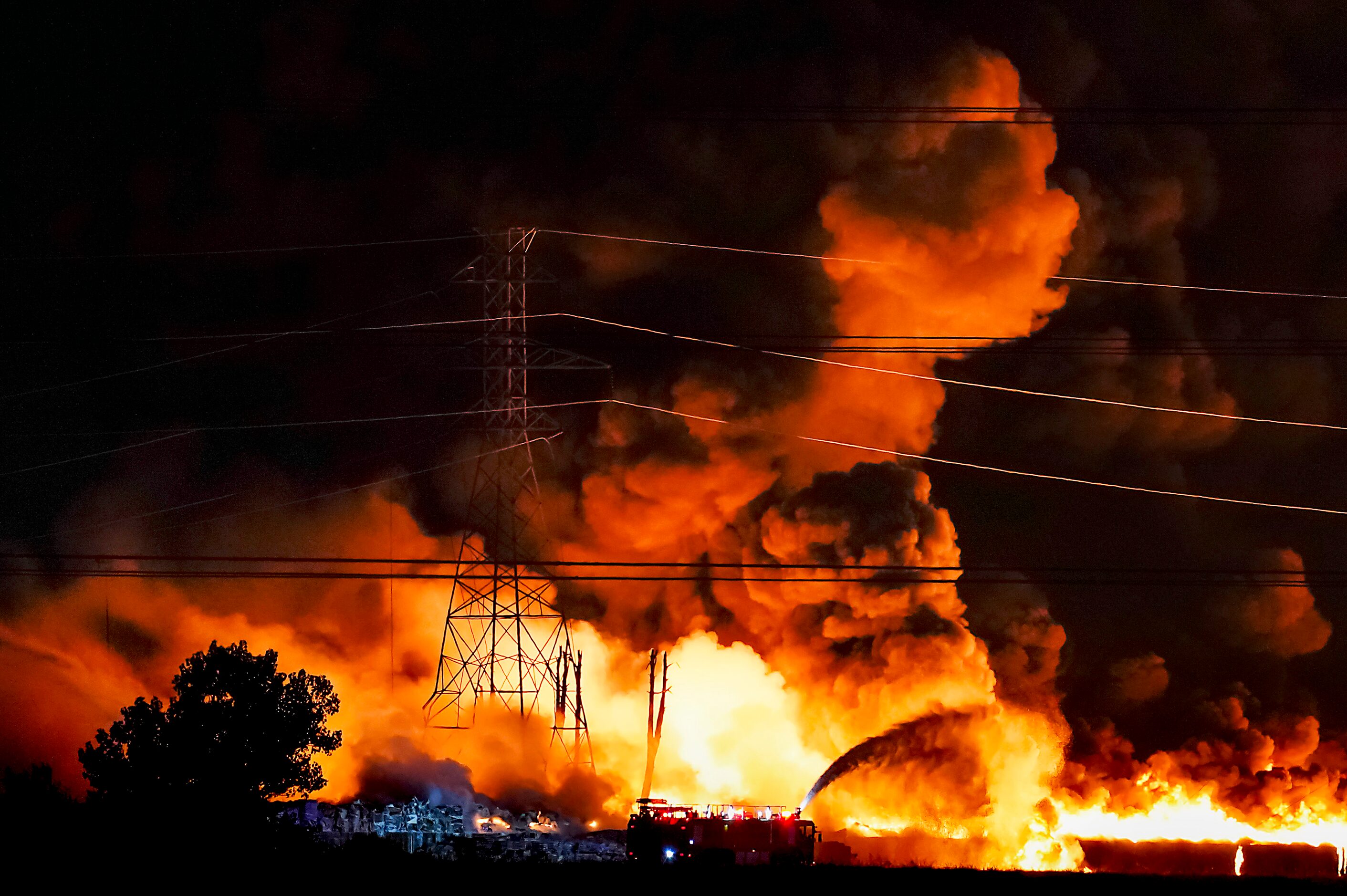 Fire crews battle a massive blaze in an industrial area of Grand Prairie in the early...