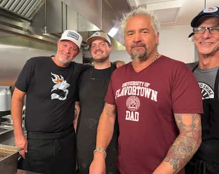 'Diners, Drive-Ins and Dives' star Guy Fieri (center right) cooked with hot chicken...