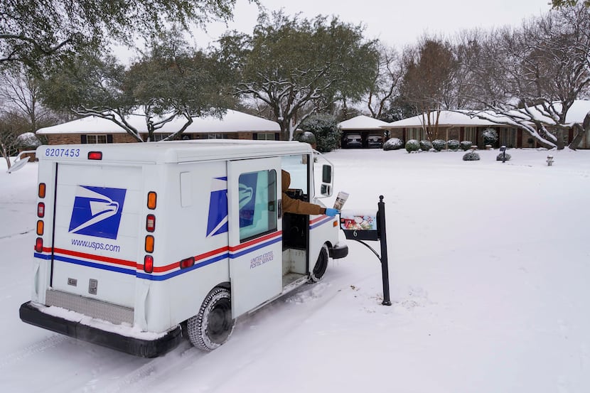 Angel Garcia delivered mail in Richardson on Feb. 17 after a second storm brought more snow...