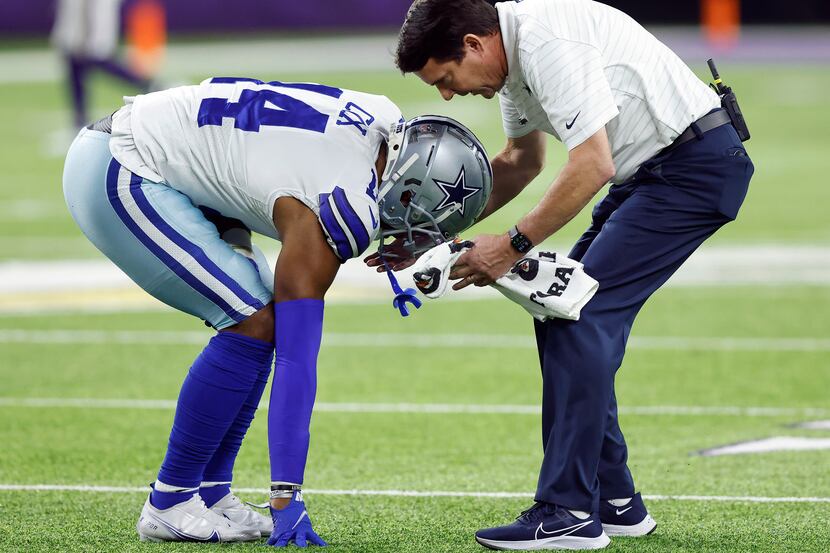 Dallas Cowboys linebacker Jabril Cox (14) tried limping off the field after sustaining a...