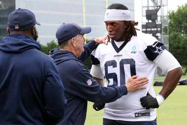 Dallas Cowboys offensive lineman Tyler Guyton (60) listens intently to offensive line coach...