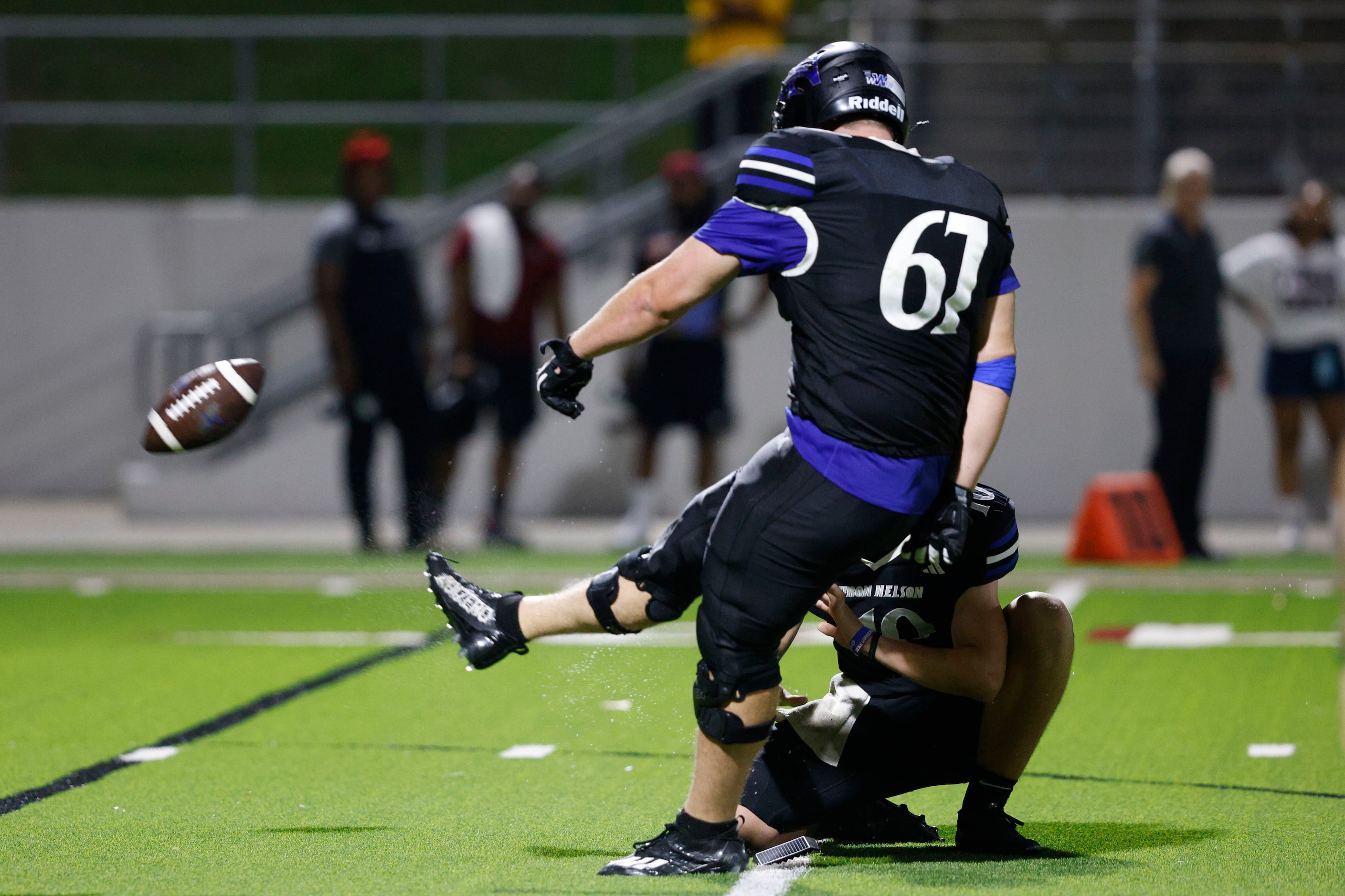 Byron Nelson's Justin Bequette (67) kicks a field goal against Lewisville during the second...