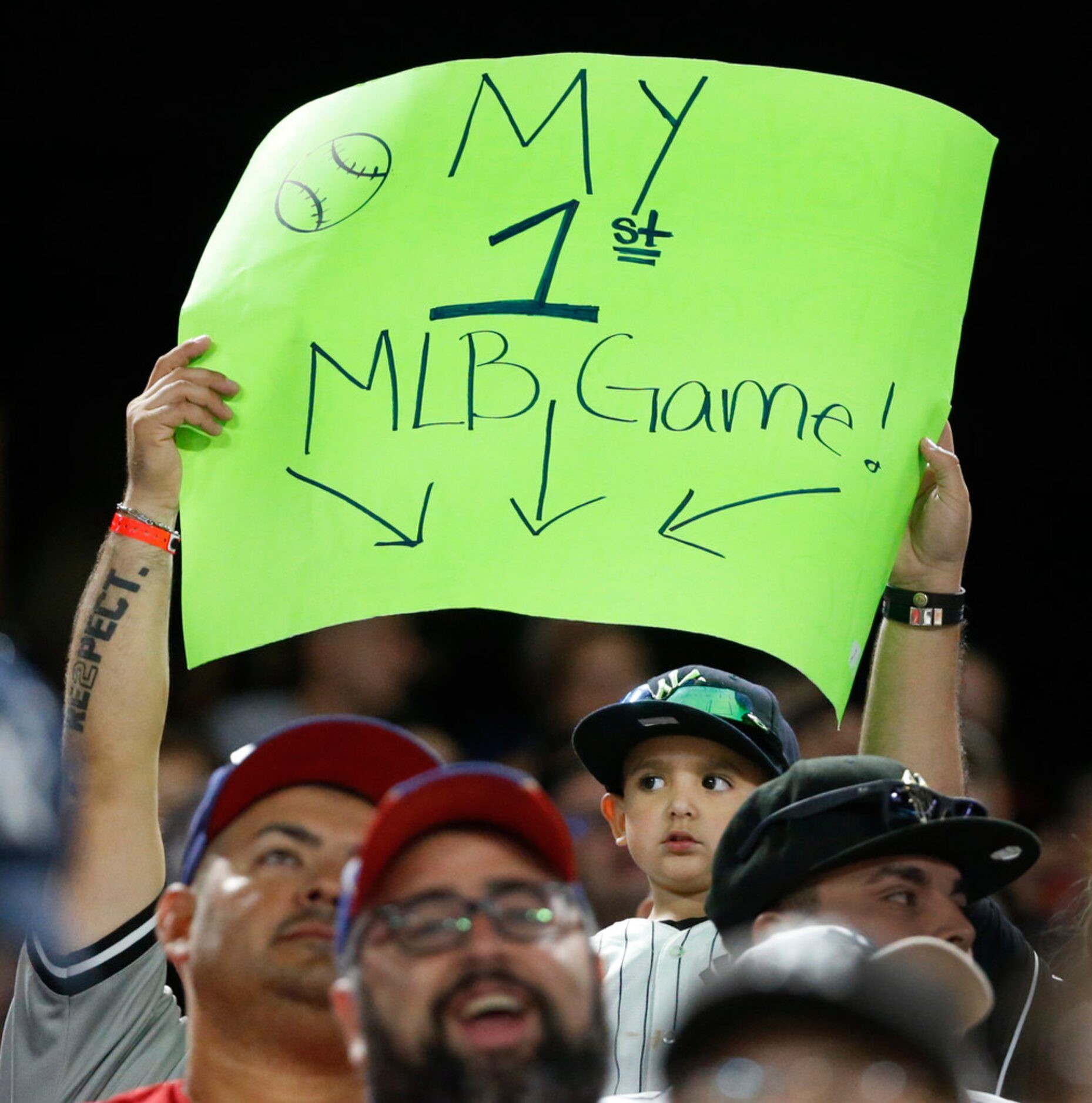 A young fan tries to draw the attention of the cameras with a sign during the New York...