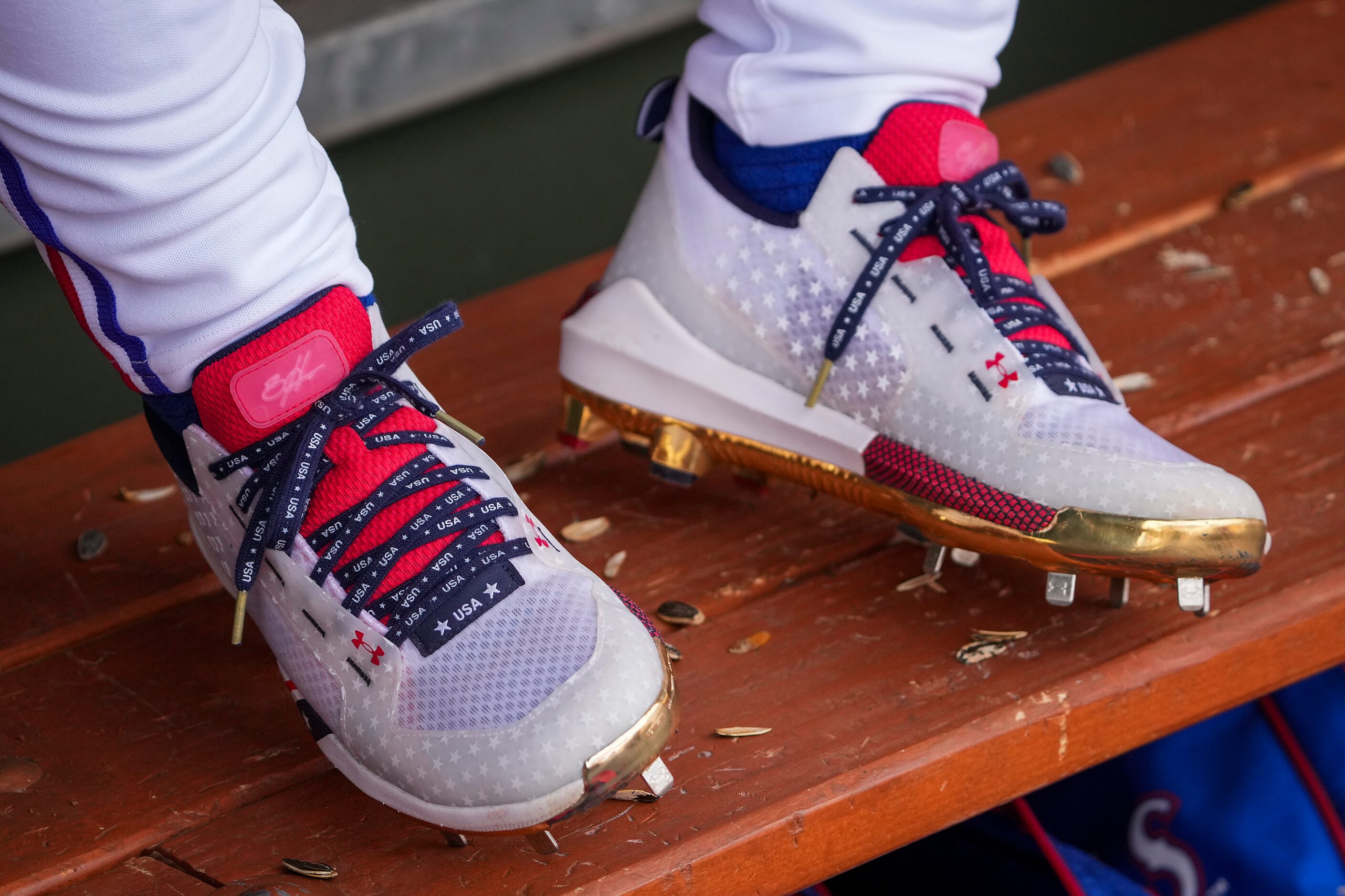 Shells of sunflower seeds collect around the spiks of Texas Rangers outfielder Steele Walker...