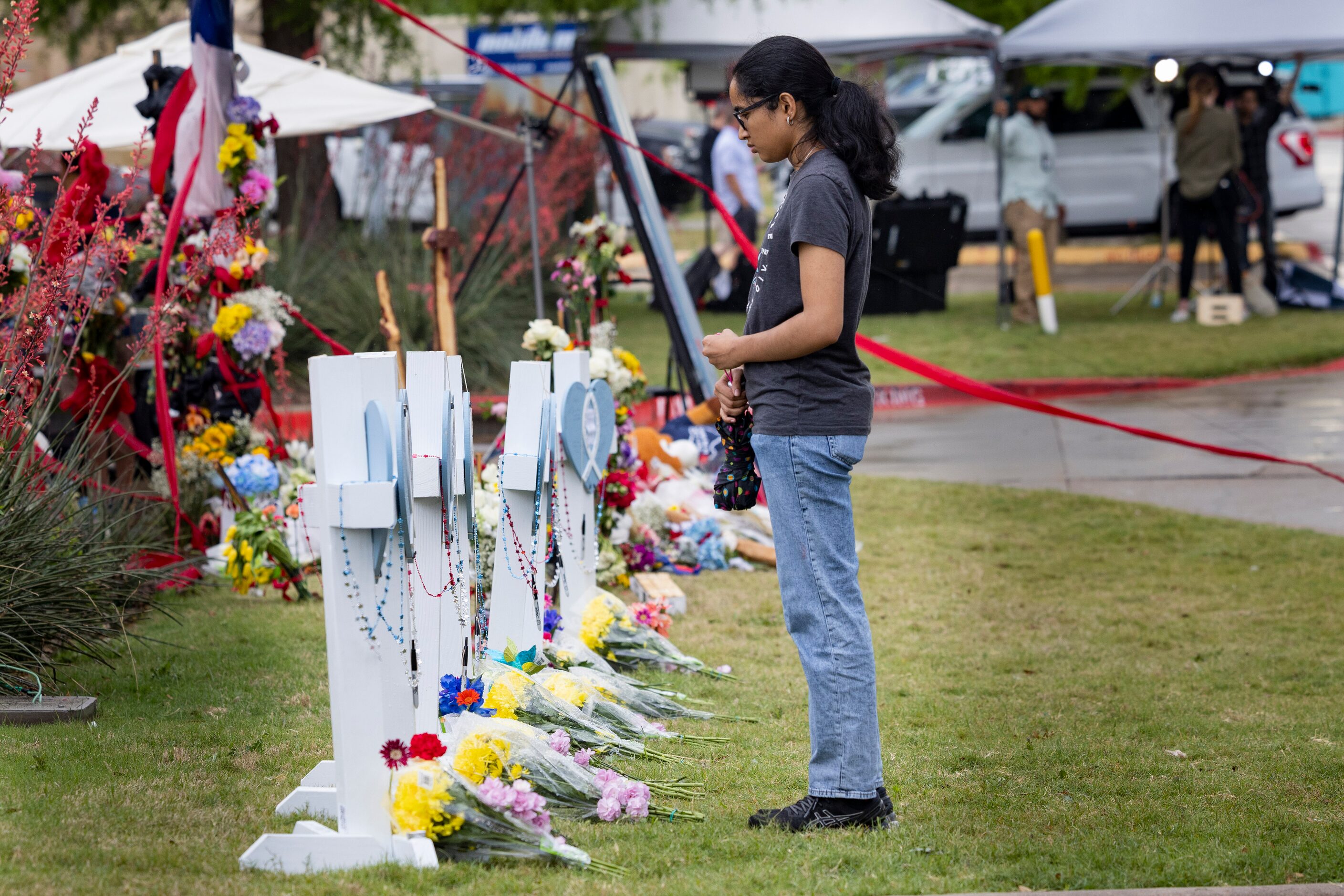 Varsha Sundararaman, 19, pauses in front of the cross for Aishwarya Thatikonda at the...