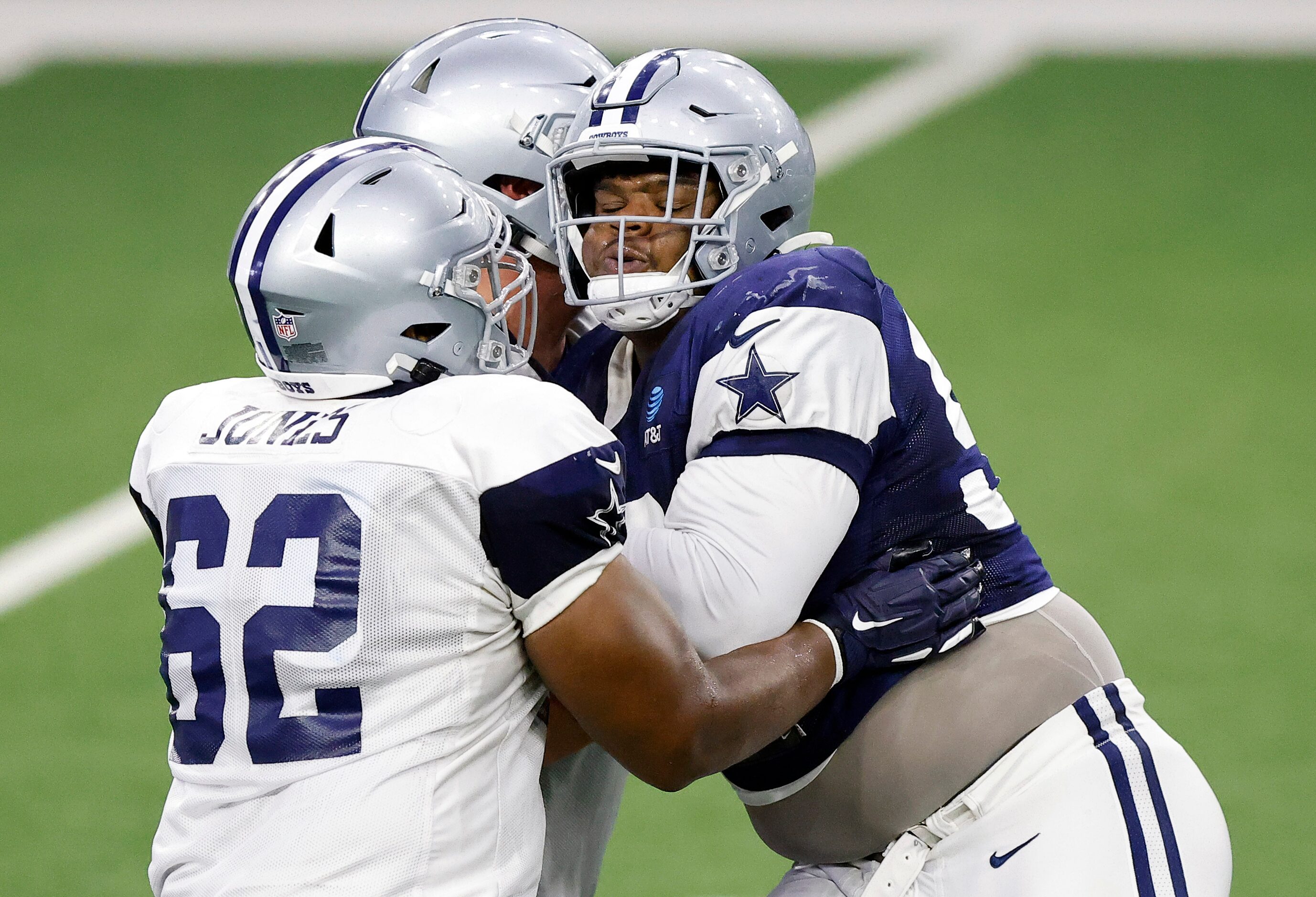 Dallas Cowboys defensive tackle Quinton Bohanna (right) is double teamed by a pair of...