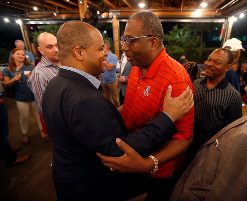 Dallas mayoral candidate and state Rep. Eric Johnson (left) is congratulated by state Sen....