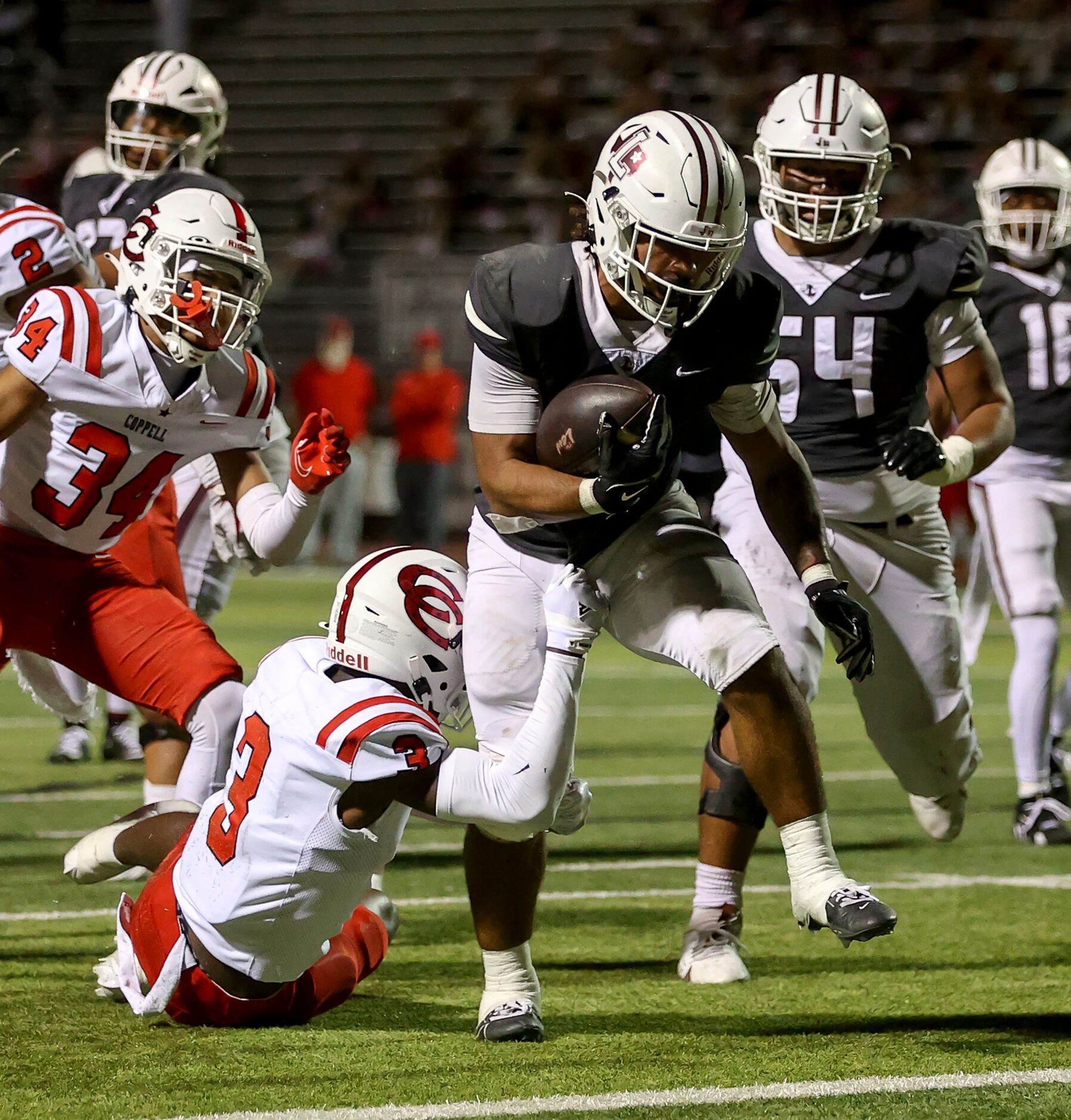 Lewisville running back Tenel Hill (9) gets past Coppell cornerback Seth Carethers (3) for a...