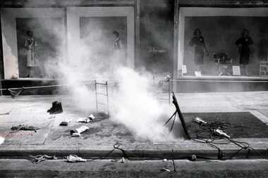 Burning underground power cables send smoke boiling from a manhole outside an Elm Street...