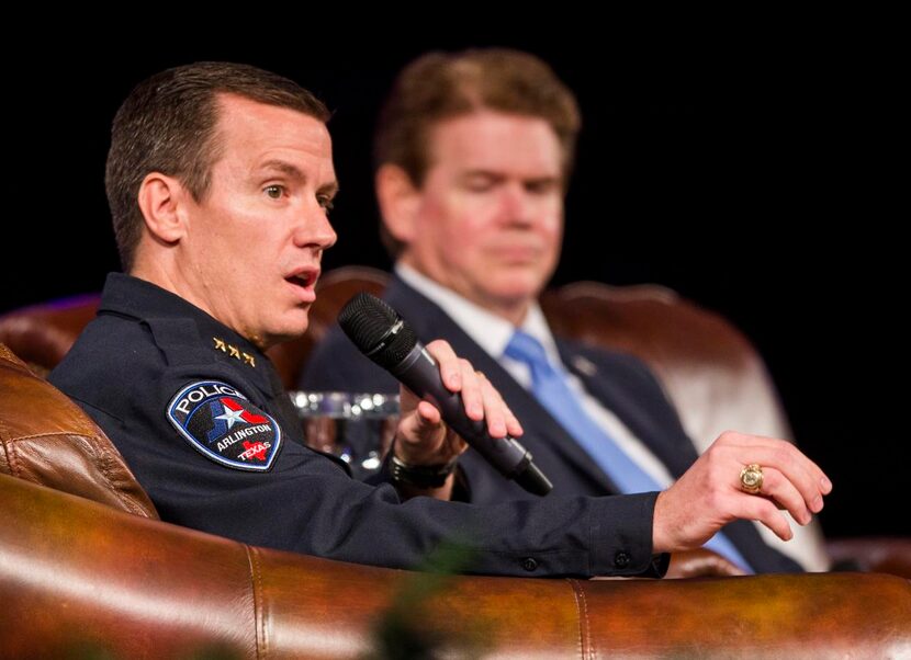 
Arlington Police Chief Will Johnson answers questions from the audience next to Arlington...