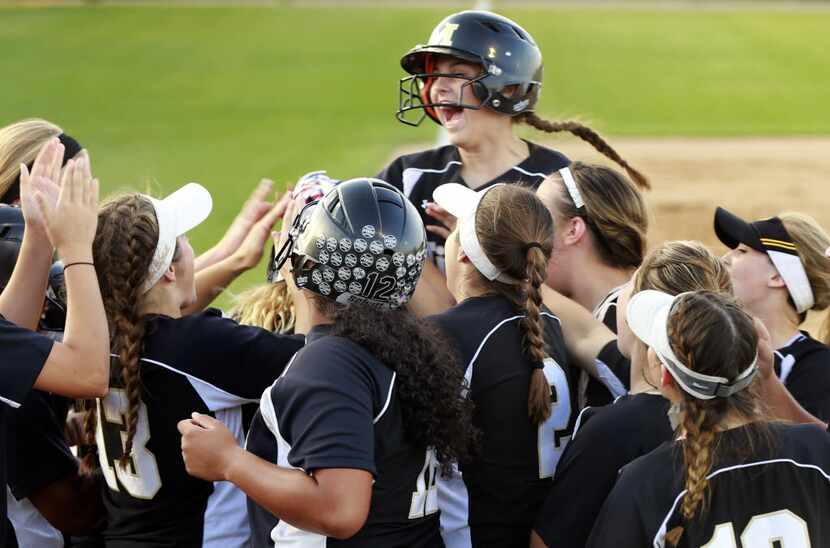 Mansfield's Reagan Hukill jumps up and down at home plate after Payton Simpkins two-run...