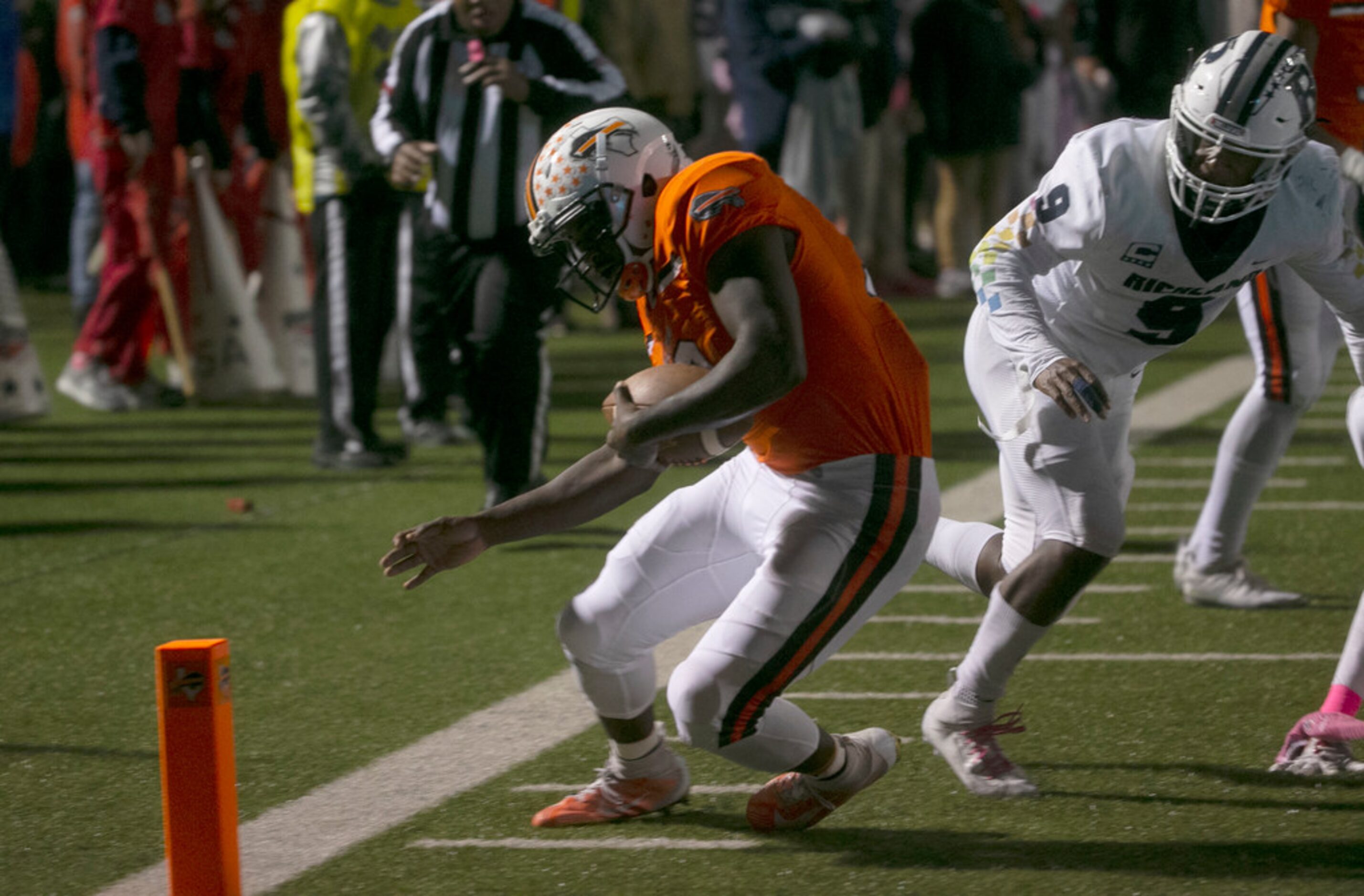 Haltom's Adam Hill gets away from Richland's Emantavius Garrison (9) to score a touchdown...