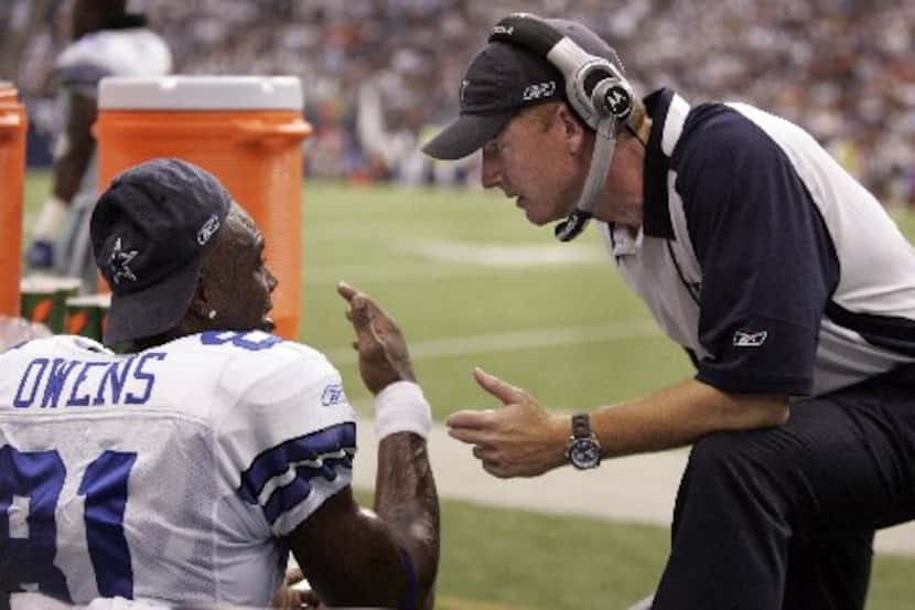 FILE - Sept. 9, 2007: Cowboys wide receiver Terrell Owens talks with assistant coach Jason...