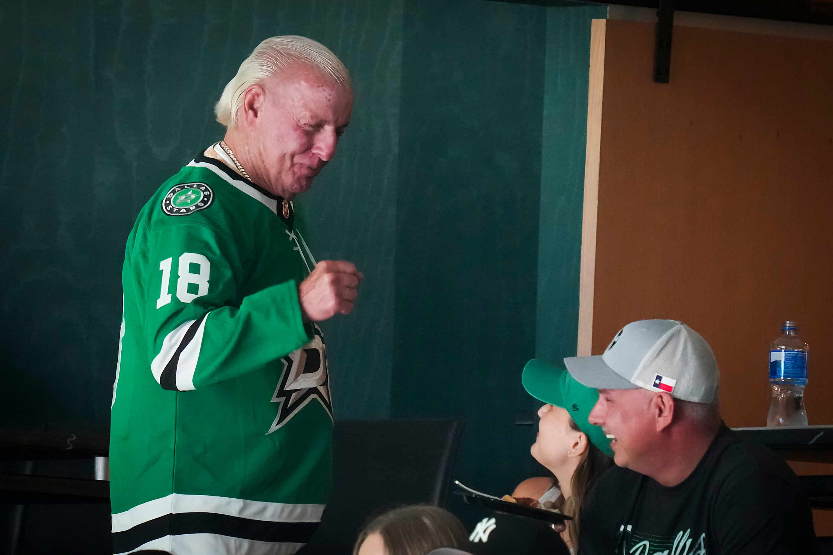 Professional wrestler Rick Flair watches from a suite during the first period in Game 6 of...