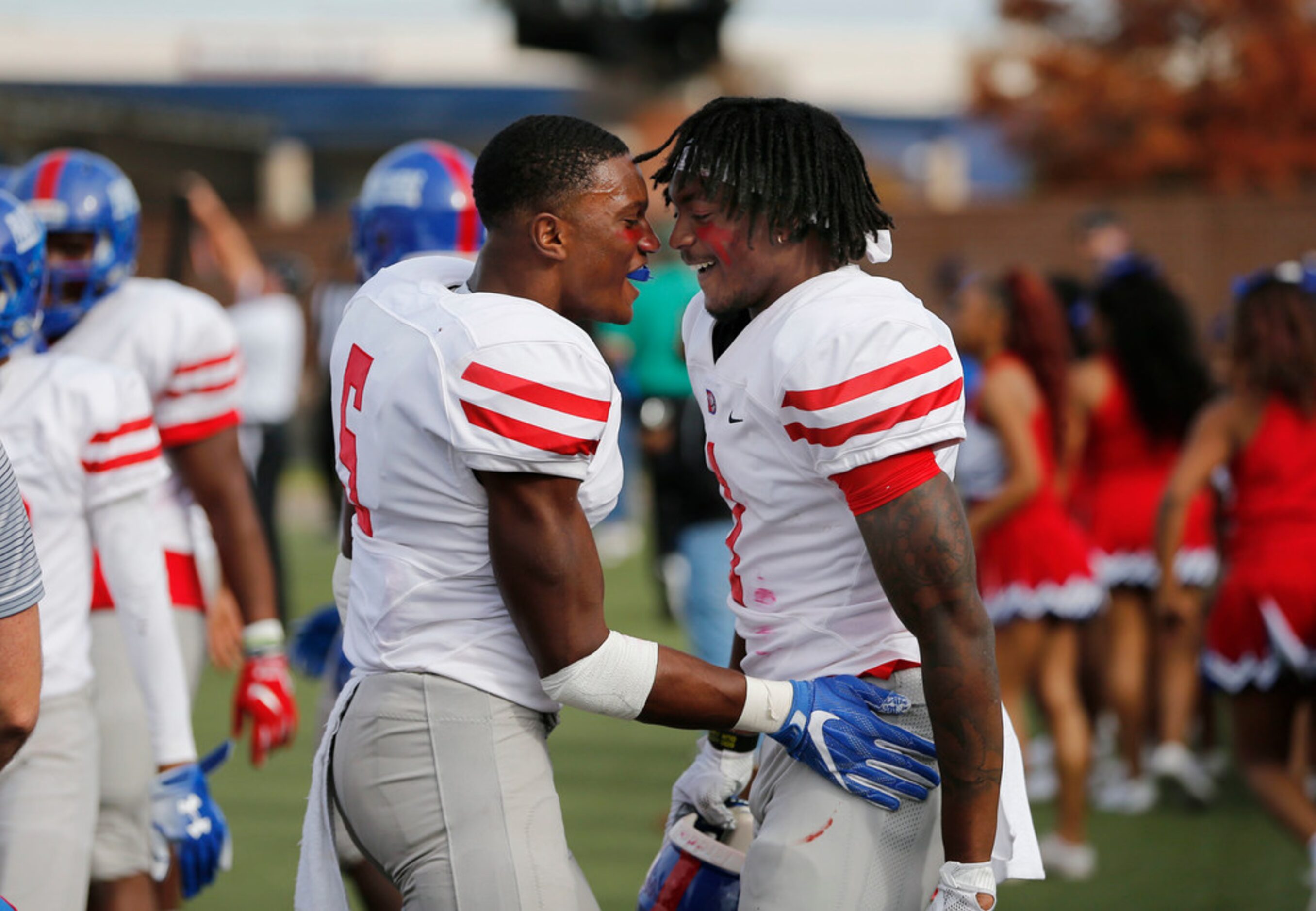 Duncanville's Chris Thompson Jr. (5), left, congratulates teammate Stacy Brown (1) right...