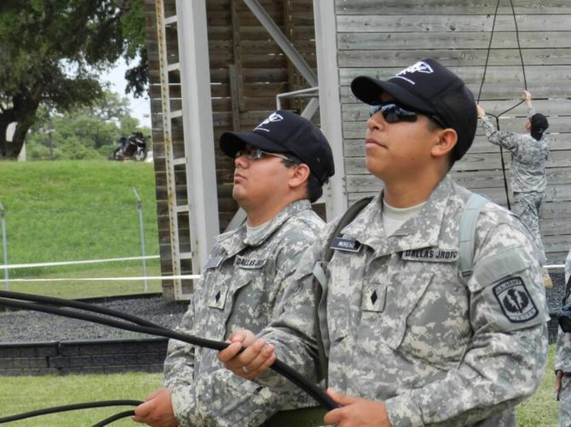 
Samuell High School JROTC cadet major Roy Moreno (right), and Skyline High School cadet...