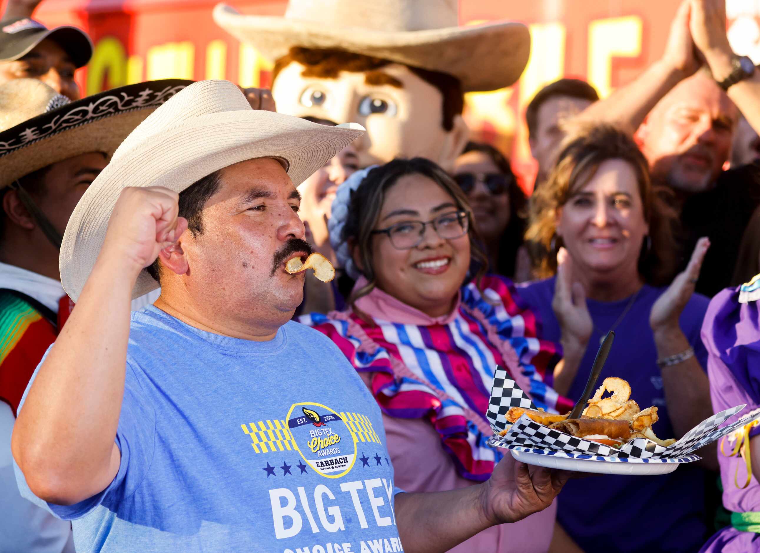 Guillermo Rodriguez, center, reacts towards the camera while holding Deep-Fried BLT, one of...