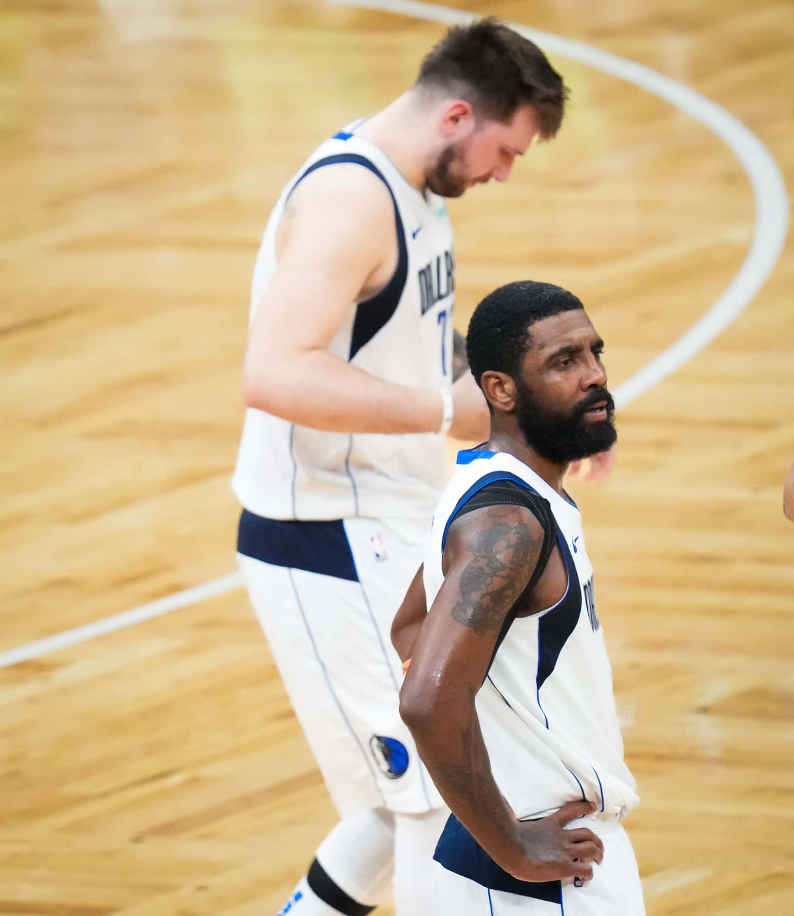 Dallas Mavericks guard Kyrie Irving (11) abd guard Luka Doncic (77) look on during a timeout...