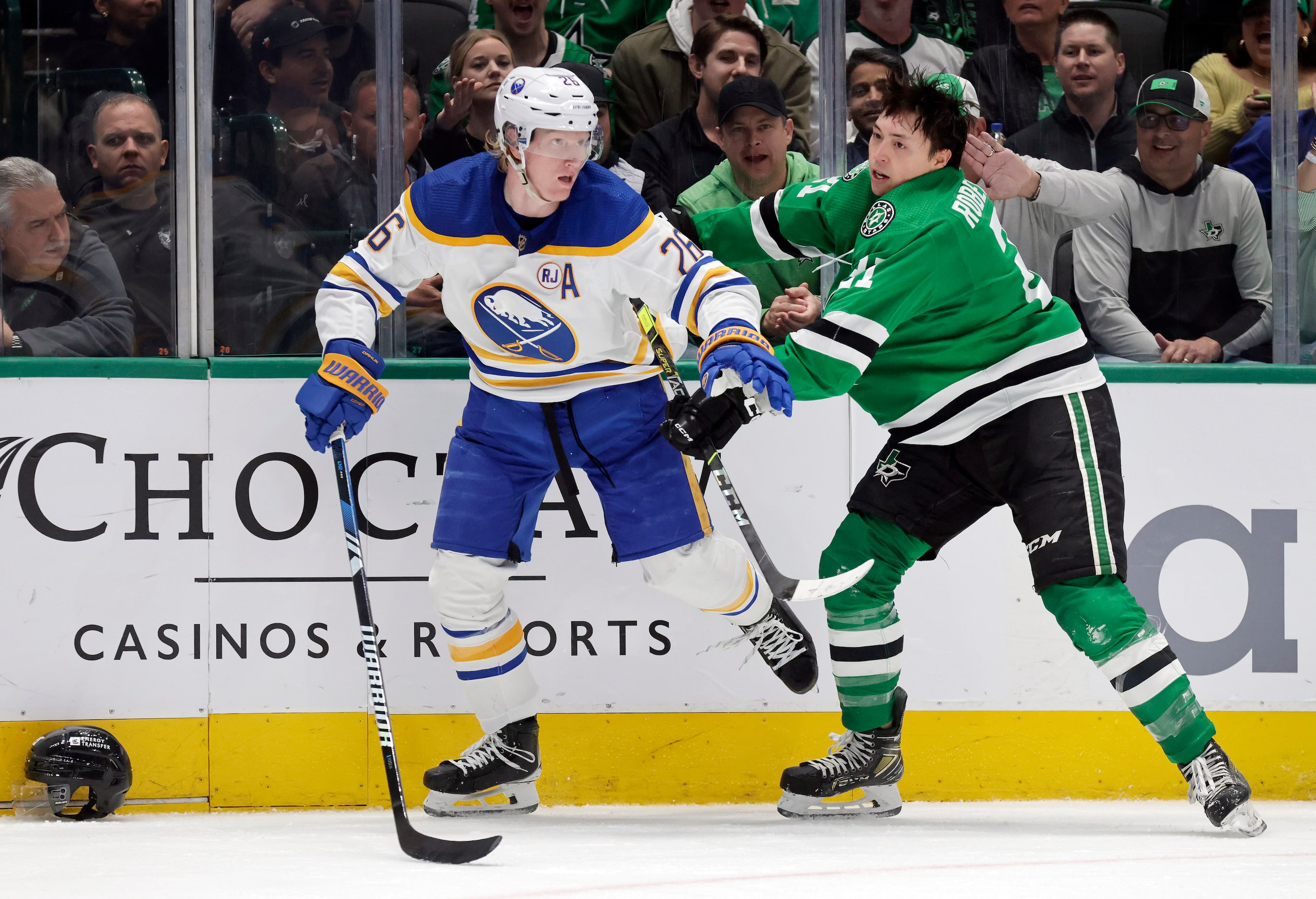 Dallas Stars left wing Jason Robertson (21) pushes off Buffalo Sabres defenseman Rasmus...