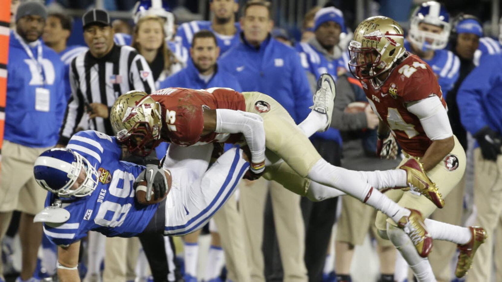 FILE - In this Saturday, Dec. 7, 2013, file photo, Duke's Braxton Deaver (89) is hit by...