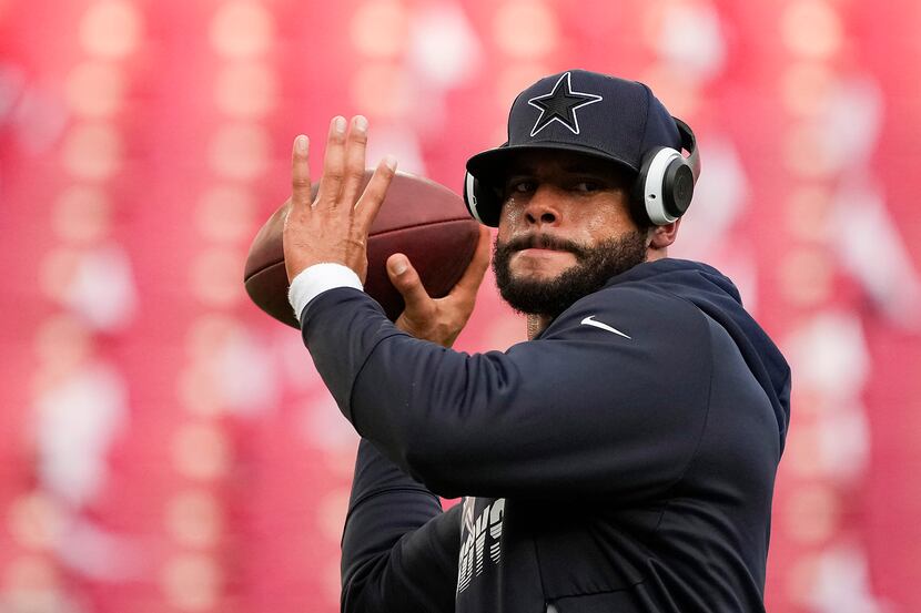Dallas Cowboys quarterback Dak Prescott warms up before an NFL football game against the...